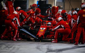 法拉利F1維修人員在車庫中更換5號賽車的輪胎。