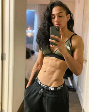穿著UGC裝備的健美女性在室內對著鏡子自拍