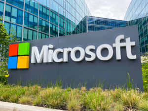 Microsoft企業標牌，位於玻璃辦公樓前，周圍有綠植。