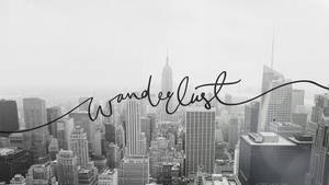 黑白城市景觀，摩天大樓上覆蓋著「Wanderlust」文字。 — 旅行 壁紙