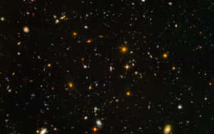 廣闊的宇宙場景，充滿了遙遠的星系和明亮的恆星，背景是黑色的虛空。