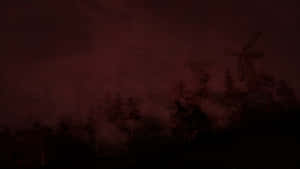 風車剪影映襯著紅色霧氣瀰漫的夜空和樹木。 — 黑暗森林 壁紙