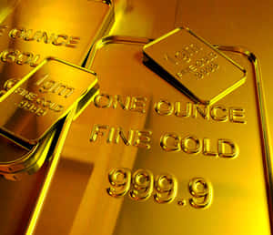 堆疊的金條標示為 one ounce fine gold 999.9，表面反光。 — 玫瑰金風格 壁紙