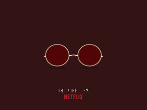 深酒紅色背景上帶有白色鏡框的紅色鏡片太陽眼鏡，並帶有 Netflix 標誌。