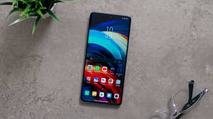 混凝土上的智能手機，附近有植物和眼鏡 — Xiaomi 壁紙