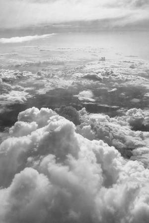 從上方俯瞰蓬鬆雲層延伸至地平線的景色。 — 唯美雲朵動態 壁紙