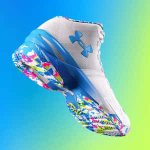 一雙色彩繽紛的 Under Armour 籃球鞋漂浮在藍色到綠色的漸變背景上。 — 1:1 壁紙
