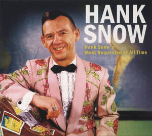 Hank Snow 身穿粉紅色花卉西裝，拿著一個貼有貼紙的旅行手提箱。 — 音樂 GIF 壁紙