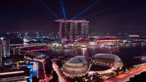 新加坡夜晚的城市景觀，有發光的建築物和水面上的激光束。