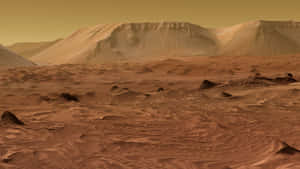 火星表面，橙色天空下有沙丘和平頂山