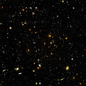 充滿遙遠星系和明亮恆星的深空視圖，背景是黑色虛空。 — 太空 壁紙