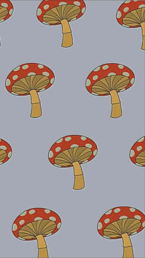紅色和白色斑點蘑菇在灰色背景上以重複圖案排列。