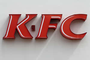 安裝在白色牆上的紅色KFC標誌字母。