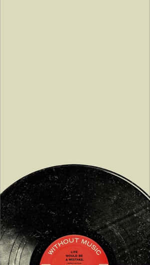黑膠唱片，帶有紅色標籤，上面寫著「Without Music Life Would Be A Mistake」，背景為米色。