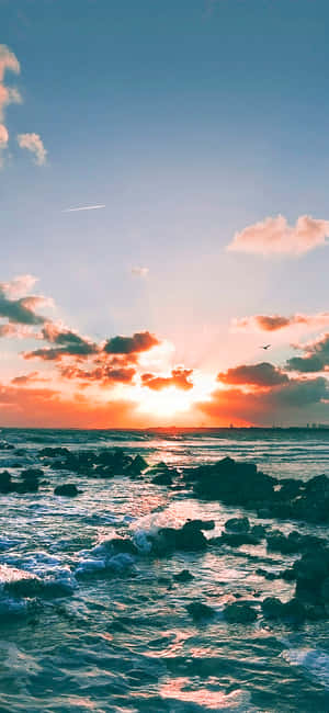 海洋上的夕陽，海浪拍打岩石