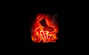 「jazz」一詞在黑色背景上被熾熱的橙色火焰吞噬。 — 火 壁紙