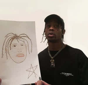 Travis Scott 拿著一幅自己臉部的草圖，下方畫有一顆星星。 — 特拉維斯·斯科特 壁紙