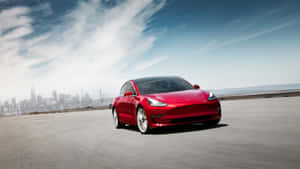 紅色Tesla Model 3在開闊的道路上行駛，背景是城市天際線。 — Tesla GIF 壁紙