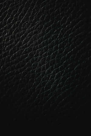 帶有可見紋理圖案的黑色皮革質感特寫。 — Huawei MatePad 11.5 (2026) 壁紙