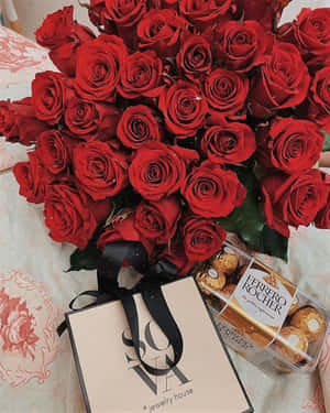 紅玫瑰、Ferrero Rocher朱古力和珠寶禮品袋放在花床罩上。 — 可愛情人節gif 壁紙