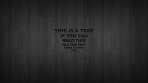 深色木紋背景，中央粗體文字顯示「THIS IS A TEST IF YOU CAN READ THIS ALL THE WAY DOWN TO HERE PLEASE」