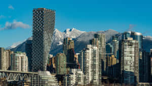 城市天際線，背景是積雪山脈，天空湛藍。 — 天際線 壁紙