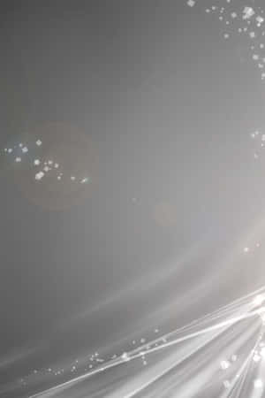 帶有發光光條和閃爍粒子的抽象灰色背景。