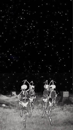 兩個骷髏在星空下的墓園裡跳舞。