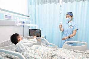 護士在病床邊照顧使用平板電腦和靜脈注射的病人