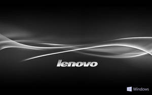 Lenovo標誌搭配黑色背景上流動的銀色波浪和Windows標誌