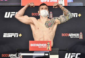UFC拳手在稱重時戴著口罩展示手臂