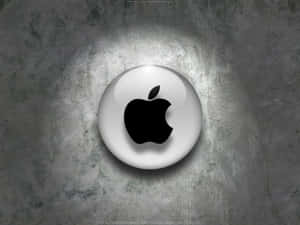 聚光燈下的紋理灰色混凝土牆上的光澤Apple標誌。
