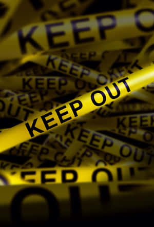 帶有黑色「KEEP OUT」文字的黃色警示帶纏結成一堆。