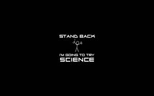白色文字和一個拿著燒杯的火柴人在黑色背景上，上面寫著「STAND BACK I'M GOING TO TRY SCIENCE」。