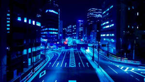 一條未來主義的城市街道在夜晚沐浴在藍色霓虹燈光中。 — 螢光藍 GIF 壁紙