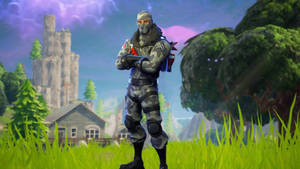 穿著迷彩裝備的Fortnite角色站在草地上，背景有城堡和樹木。