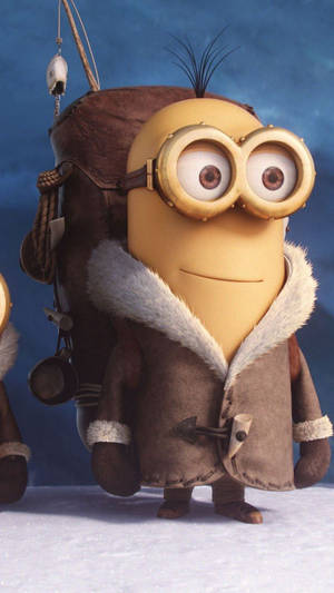 黃色Minion穿著冬季外套和護目鏡站在雪中。