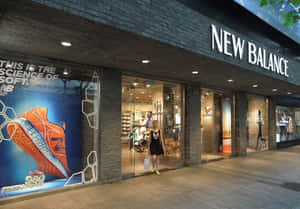 女子在夜晚走過New Balance鞋店，櫥窗上有巨大的橙色運動鞋廣告。