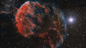 深空星群中帶有紅色和藍色雲彩的多彩星雲。 — 星際寶貝 壁紙