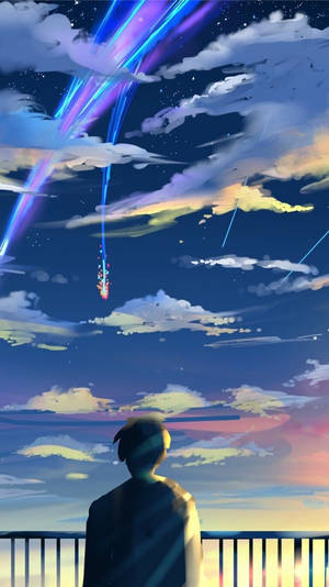 人在暮色天空中觀看多彩的宇宙條紋。