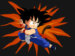 動畫角色悟空身穿藍色道服，在黑色背景下以橙色能量氣場出拳。 — 悟空 壁紙
