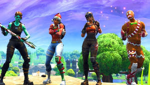 四個穿著節日服裝的 Fortnite 角色在節日戶外場景中擺姿勢。 — Fortnite 造型 壁紙