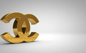 白色背景上的金色 Chanel 標誌 — 金色美學 GIF 壁紙