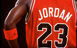 身穿紅色籃球球衣嘅運動員，名字係 Jordan，號碼係 23。 — 邁克爾·喬丹 壁紙