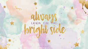 勵志名言「always look on the bright side」以金色字體書寫在帶有星星的粉彩水彩背景上 — 美學電腦 壁紙