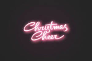 在黑暗背景上寫有 Christmas Cheer 的粉紅色霓虹燈牌