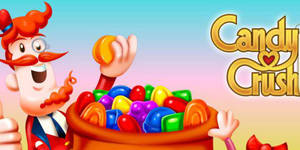 Candy Crush 遊戲吉祥物拎住一粒糖，旁邊有一碗彩色軟糖 — 約翰·坎迪 GIF 壁紙