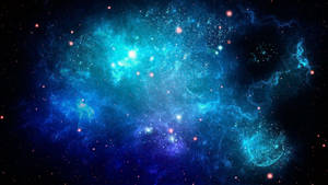 一個在深空中充滿星星的發光藍色和藍綠色星雲。