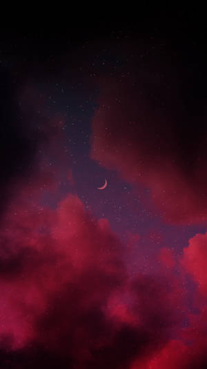 新月在繁星夜空中的紅雲之上