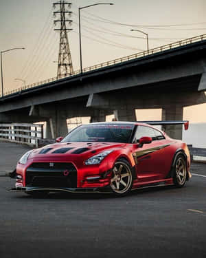 黃昏時停泊在天橋下的紅色改裝日產GT-R。 — 汽車 壁紙